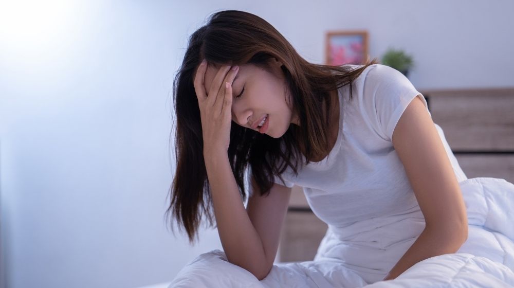 a women having headache | Feature | Hormone Health: Signs of Low Progesterone